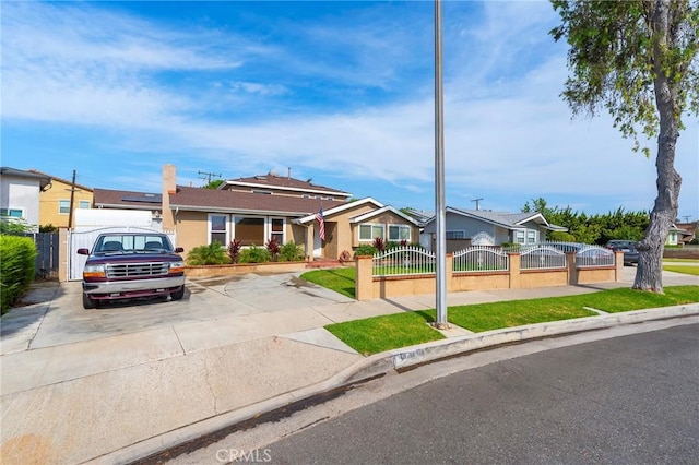 ranch-style house with a fenced front yard, a gate, and a residential view