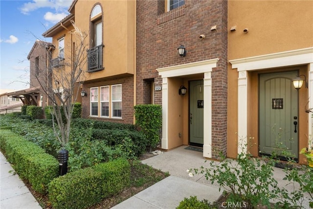 view of exterior entry with brick siding