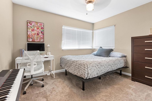 carpeted bedroom featuring baseboards and a ceiling fan