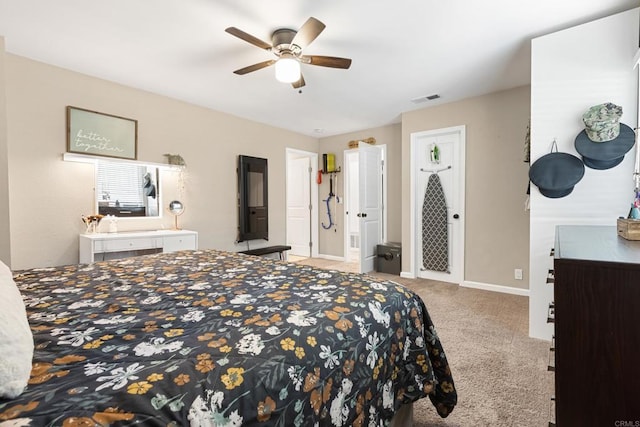 carpeted bedroom with baseboards, visible vents, and a ceiling fan