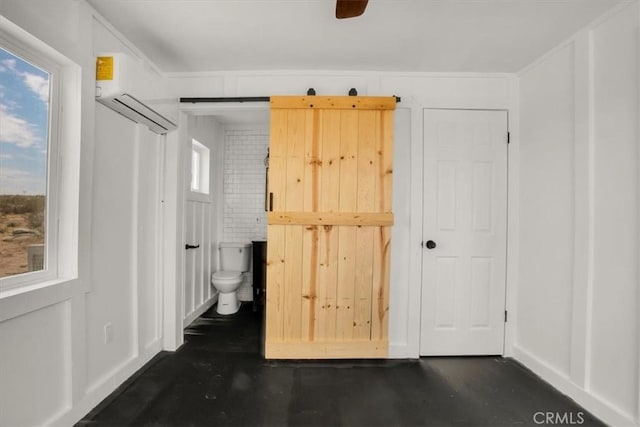 interior space with a wall unit AC and a healthy amount of sunlight