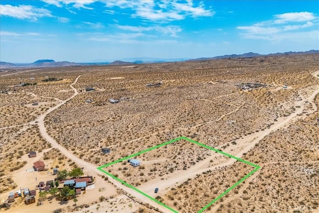 birds eye view of property featuring view of desert and a mountain view