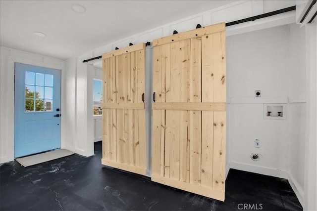 doorway featuring concrete flooring, a barn door, and a wall unit AC