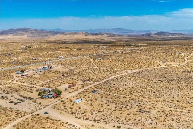 aerial view featuring a desert view and a mountain view