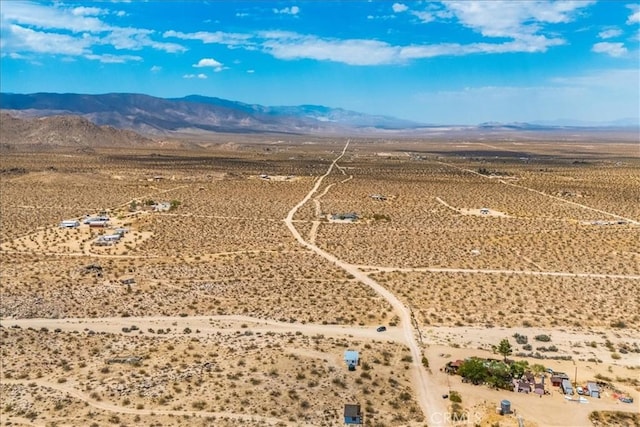 birds eye view of property with a desert view and a mountain view