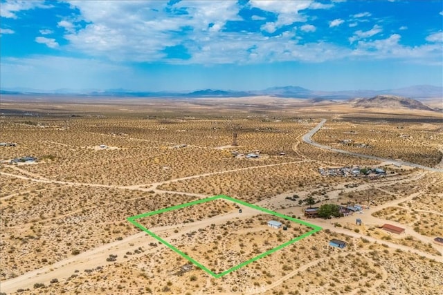 drone / aerial view with view of desert and a mountain view