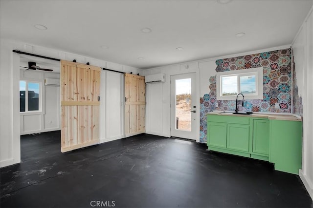 interior space with concrete flooring, a wall mounted AC, and a sink