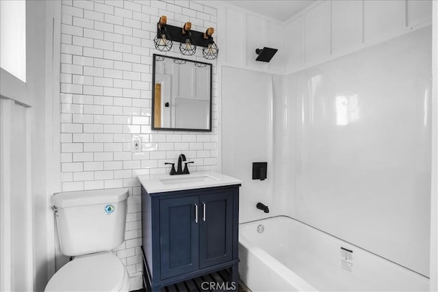 bathroom with shower / bath combination, decorative backsplash, toilet, vanity, and tile walls