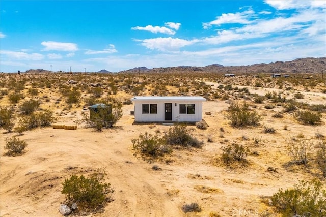 exterior space featuring a mountain view and a desert view