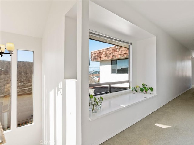 interior space with lofted ceiling and carpet