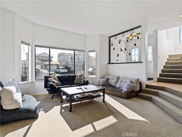 carpeted living room with stairway
