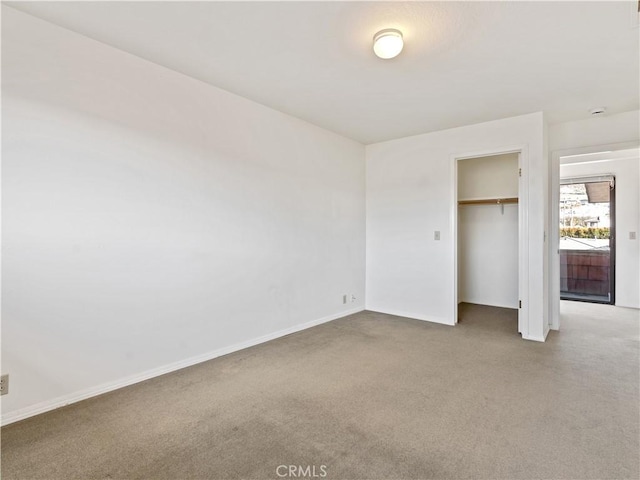 unfurnished bedroom featuring a closet, carpet flooring, and baseboards