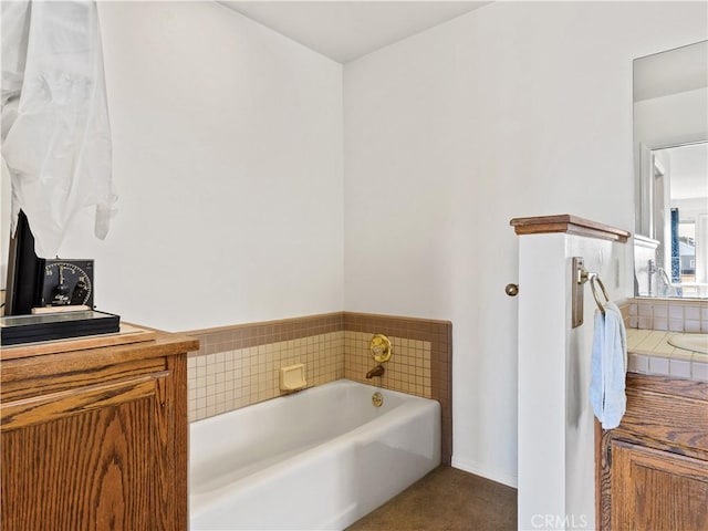 bathroom with backsplash, a garden tub, and vanity