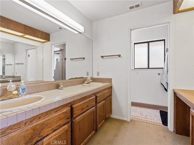 bathroom featuring carpet floors, visible vents, a sink, and double vanity