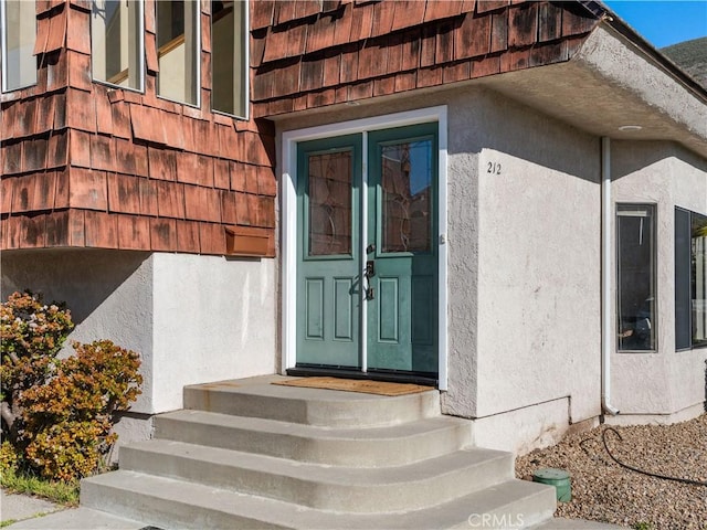 doorway to property with stucco siding