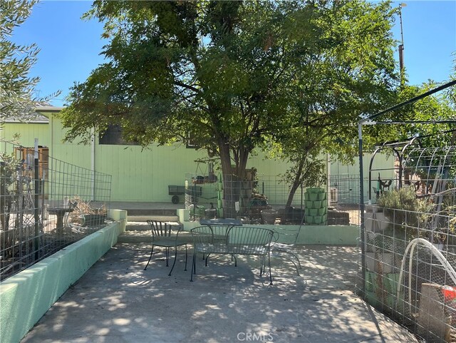 view of patio / terrace with outdoor dining area and fence