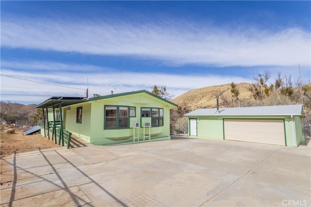 view of front facade with a garage and a mountain view