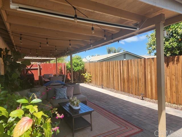 view of patio / terrace featuring a fenced backyard and an outdoor living space