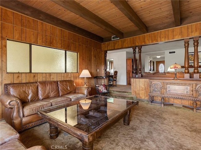 living area featuring wood ceiling, carpet flooring, wood walls, and beam ceiling