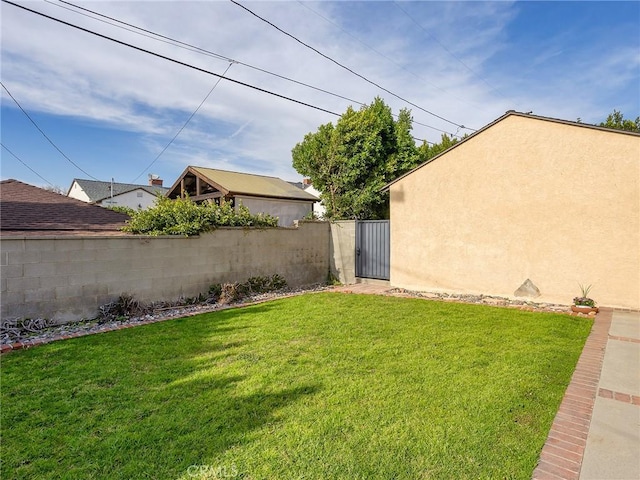 view of yard featuring a gate and fence