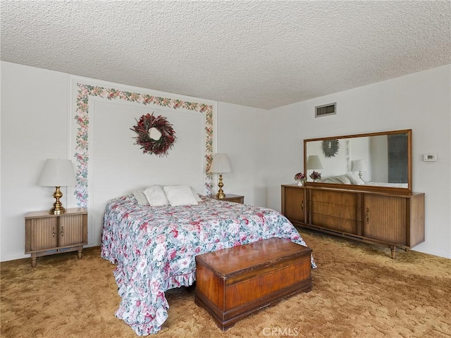 carpeted bedroom featuring visible vents and a textured ceiling