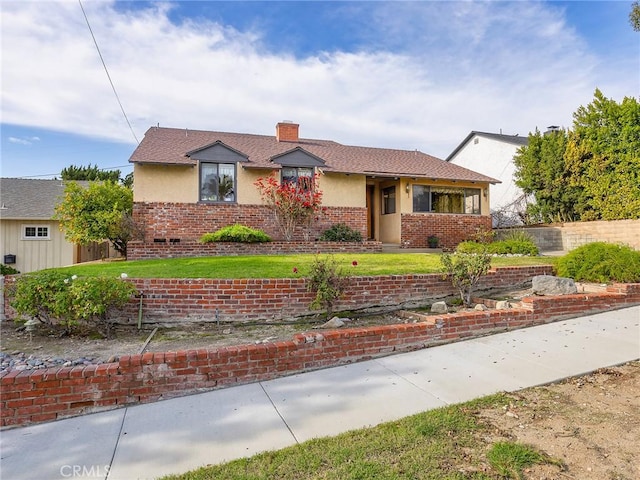 view of front of house with brick siding, fence, a chimney, and stucco siding