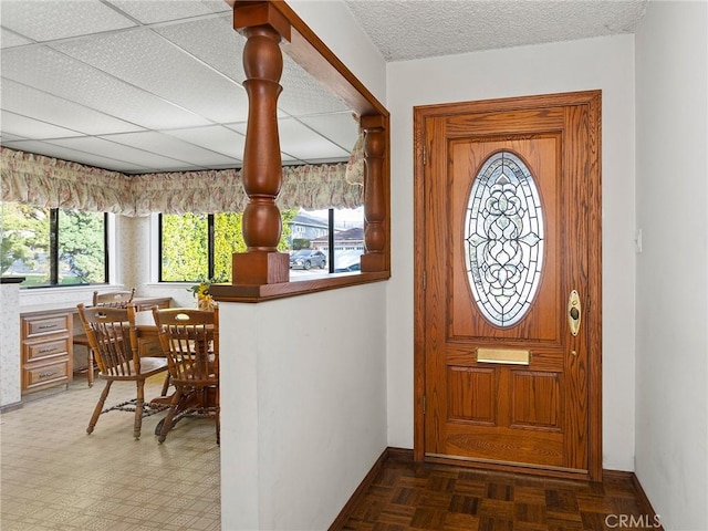 foyer with a textured ceiling, a wealth of natural light, and baseboards