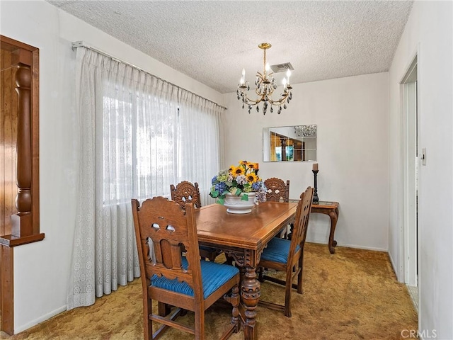 carpeted dining space featuring an inviting chandelier, visible vents, and a textured ceiling