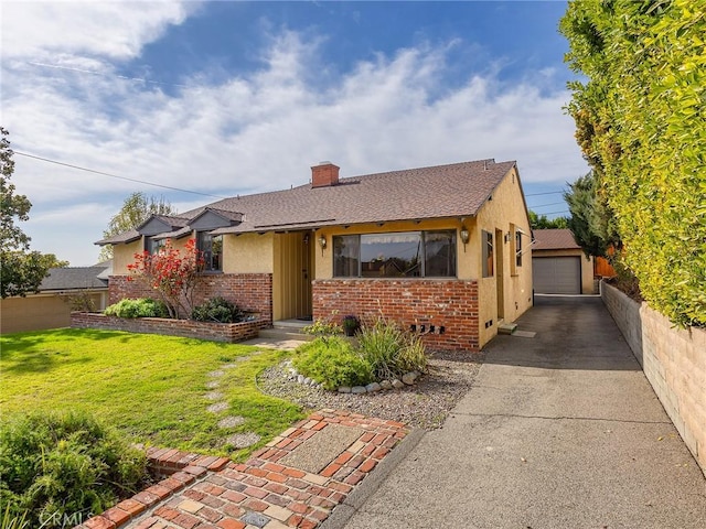 view of front of house featuring an outbuilding, brick siding, a chimney, and a front lawn