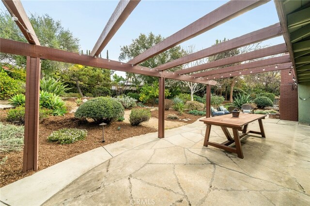 view of patio with outdoor dining space and a pergola