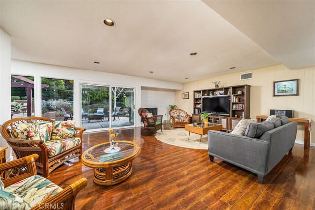 living area with recessed lighting, visible vents, dark wood finished floors, and a fireplace