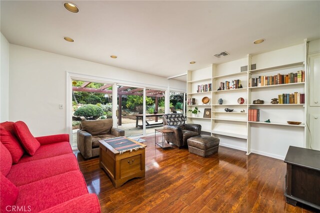 living room with dark wood finished floors, visible vents, and recessed lighting