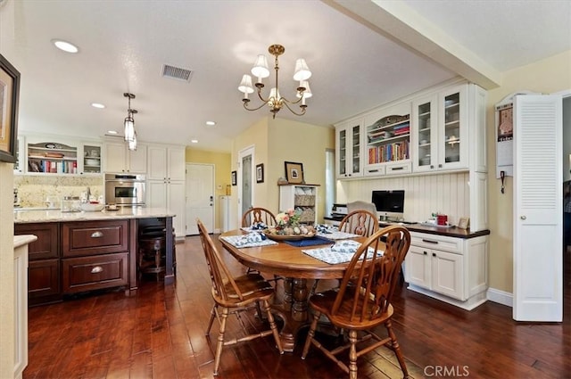 dining space featuring visible vents, a chandelier, dark wood-type flooring, and recessed lighting