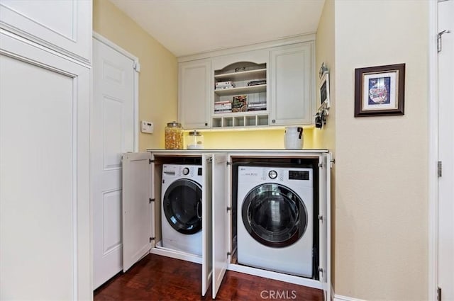 washroom with dark wood finished floors, laundry area, and independent washer and dryer