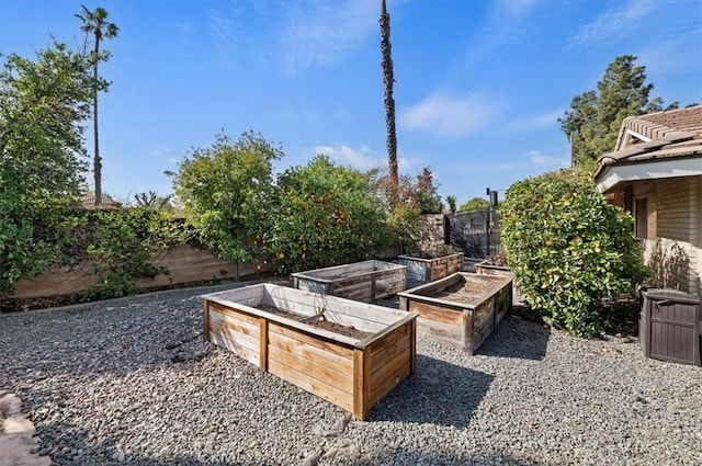 view of yard featuring a vegetable garden and fence