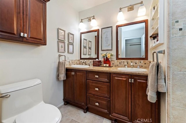 full bath with a sink, decorative backsplash, and double vanity