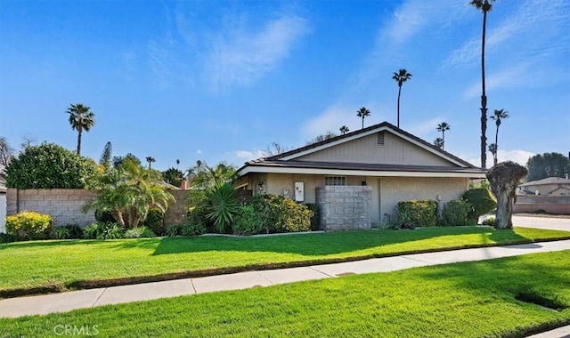 view of front of property with a front lawn and fence