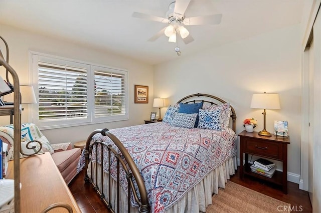 bedroom with ceiling fan and dark wood-style flooring