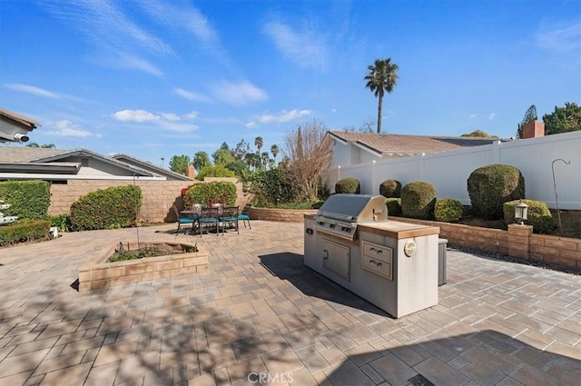 view of patio / terrace with a grill, outdoor dining area, a fenced backyard, and area for grilling