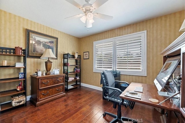 office area with baseboards, ceiling fan, dark wood finished floors, and wallpapered walls