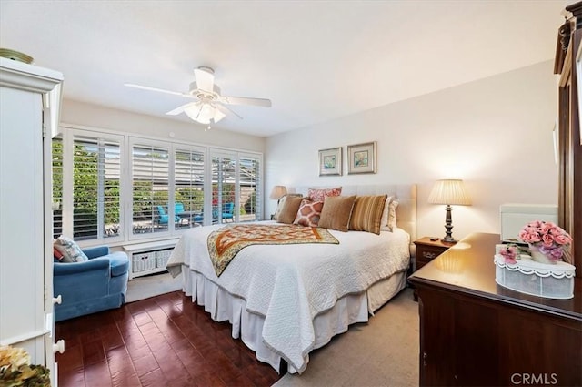 bedroom featuring a ceiling fan and dark wood-type flooring