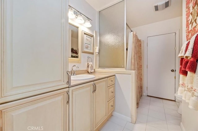 full bath with a shower with curtain, visible vents, vanity, and tile patterned floors