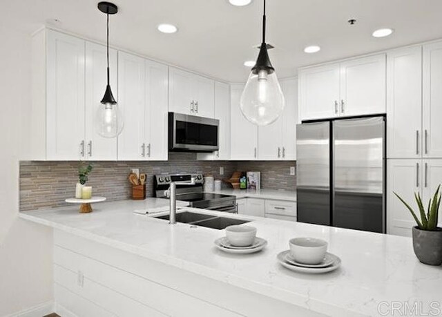 kitchen featuring stainless steel appliances, white cabinets, backsplash, and recessed lighting