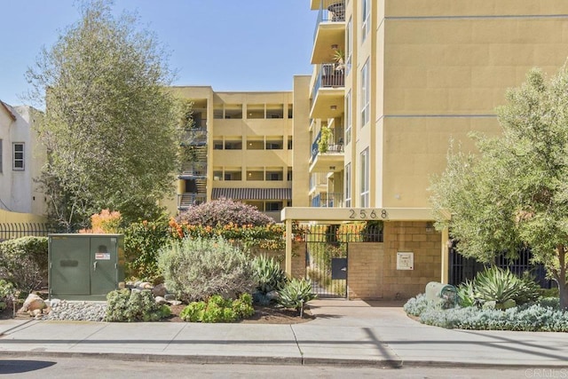 view of apartment building / complex with fence