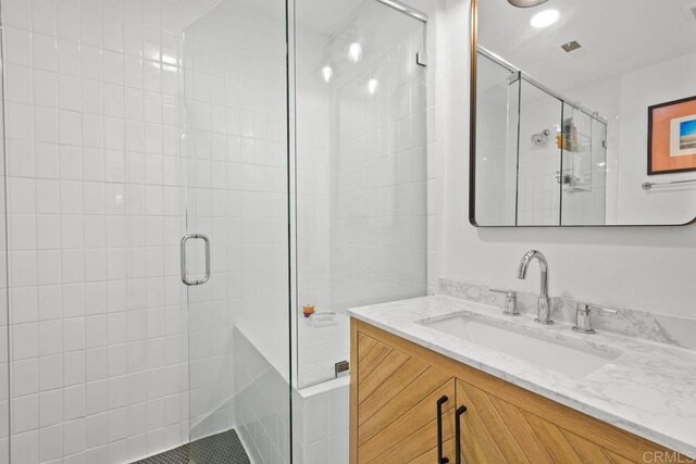 full bath featuring a shower stall and vanity