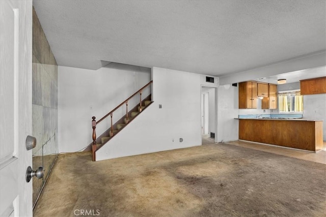 unfurnished living room featuring stairs, carpet, and visible vents