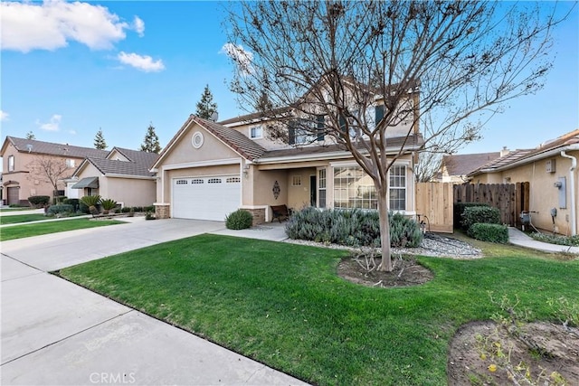 view of front of home featuring stucco siding, concrete driveway, a front yard, fence, and a garage