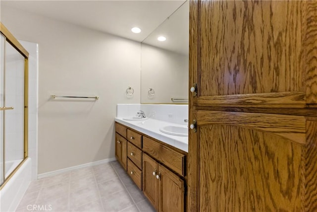 bathroom featuring double vanity, tile patterned floors, a sink, and recessed lighting