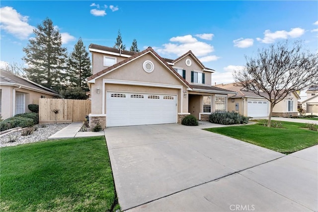 traditional-style home featuring an attached garage, fence, driveway, stucco siding, and a front lawn