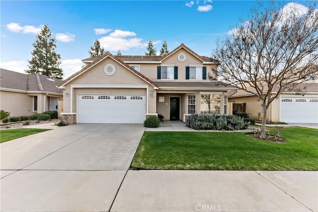 traditional home featuring a garage, concrete driveway, a front yard, and stucco siding